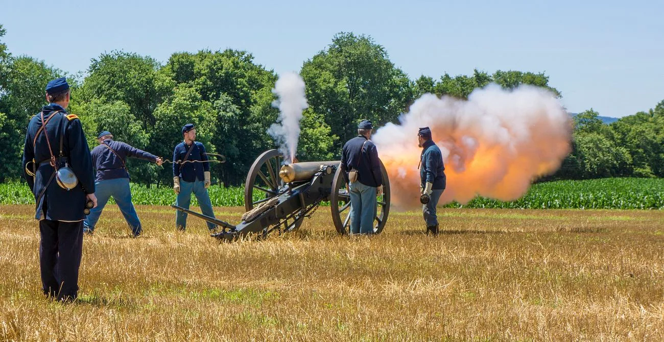 A Civil War artillery crew working a field cannon at the moment it fires